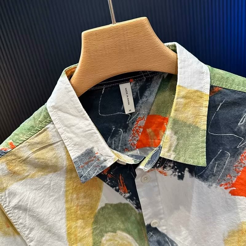 Close-up of the collar and upper placket, showing the painted print and the crinkled texture of the cotton.