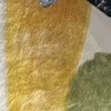 Close-up of a warm ochre brushstroke on the cotton.
